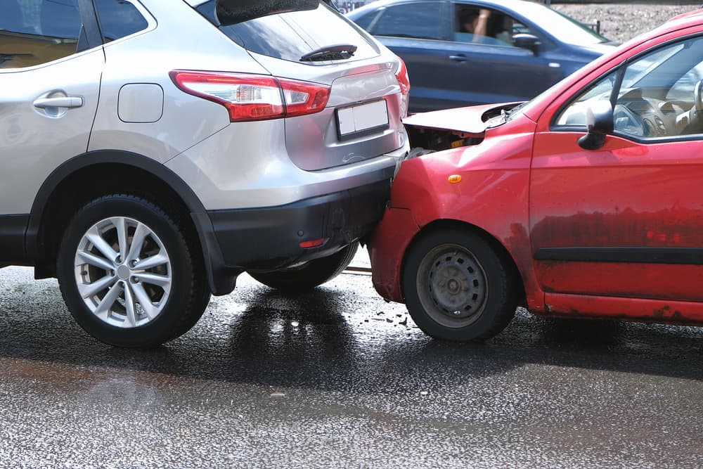 City street accident leaves cars damaged after collision.