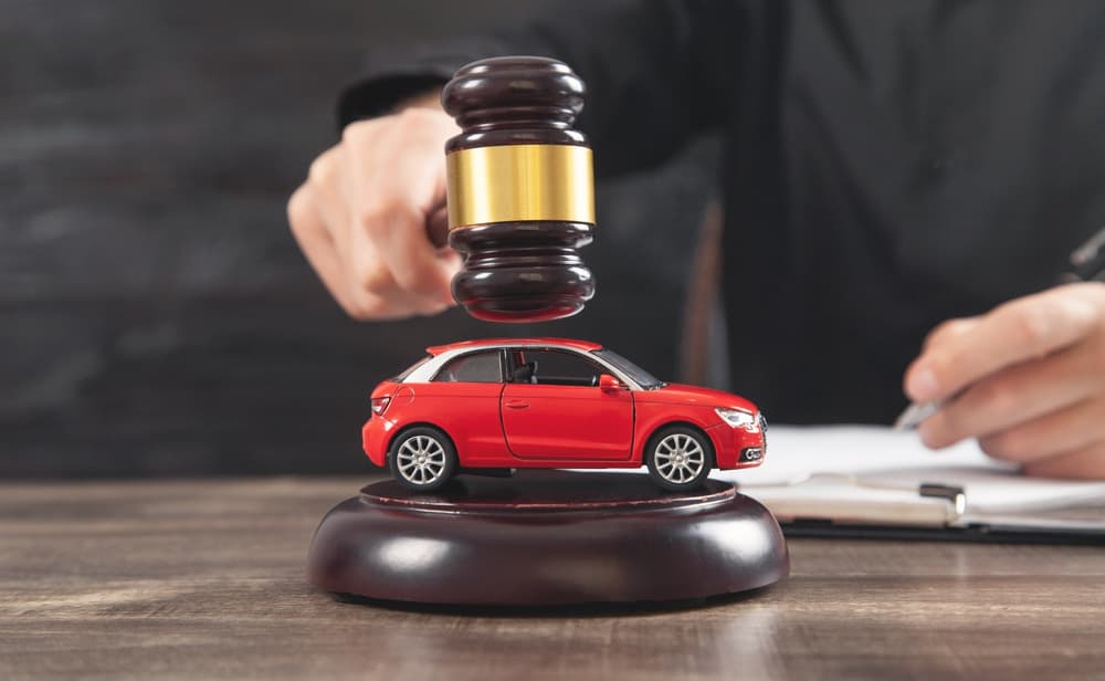 Car Accident Lawyer striking the gavel over car