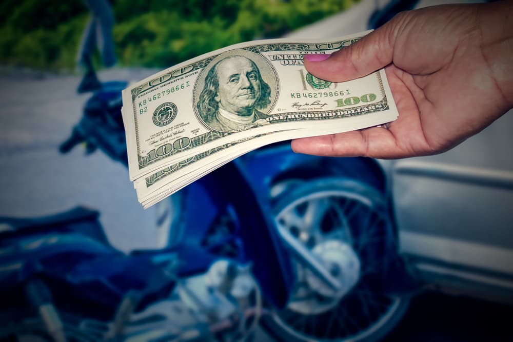 Person giving money as compensation of motorcycle accident