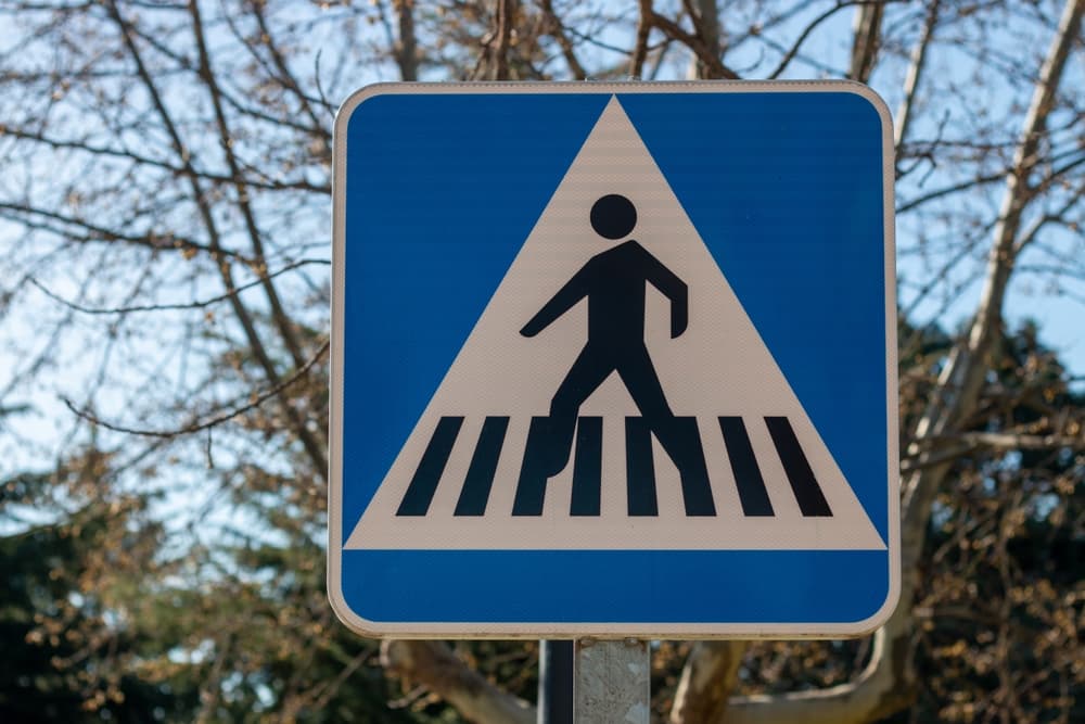 Traffic sign indicates zebra or pedestrian crossing